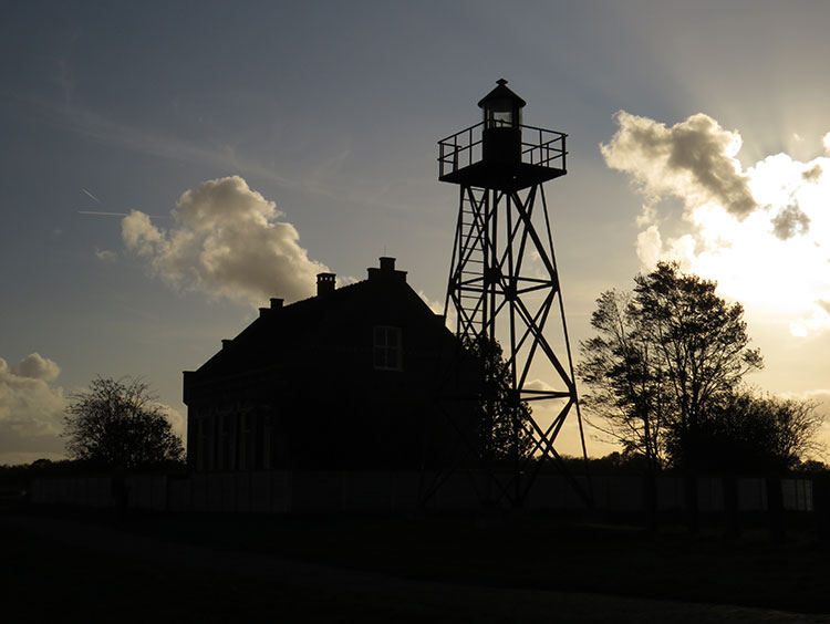 Silhouette of the lighthouse and a 'normal' house